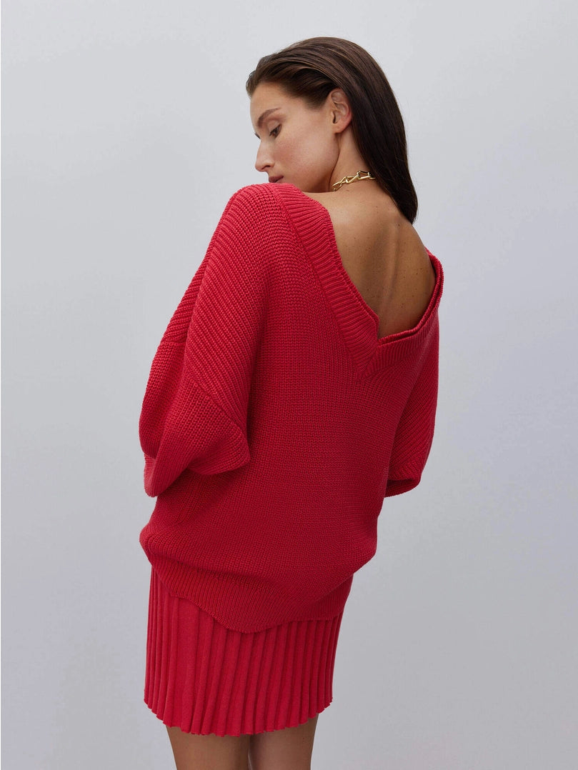 Cutout sweater with flower accessory. Red